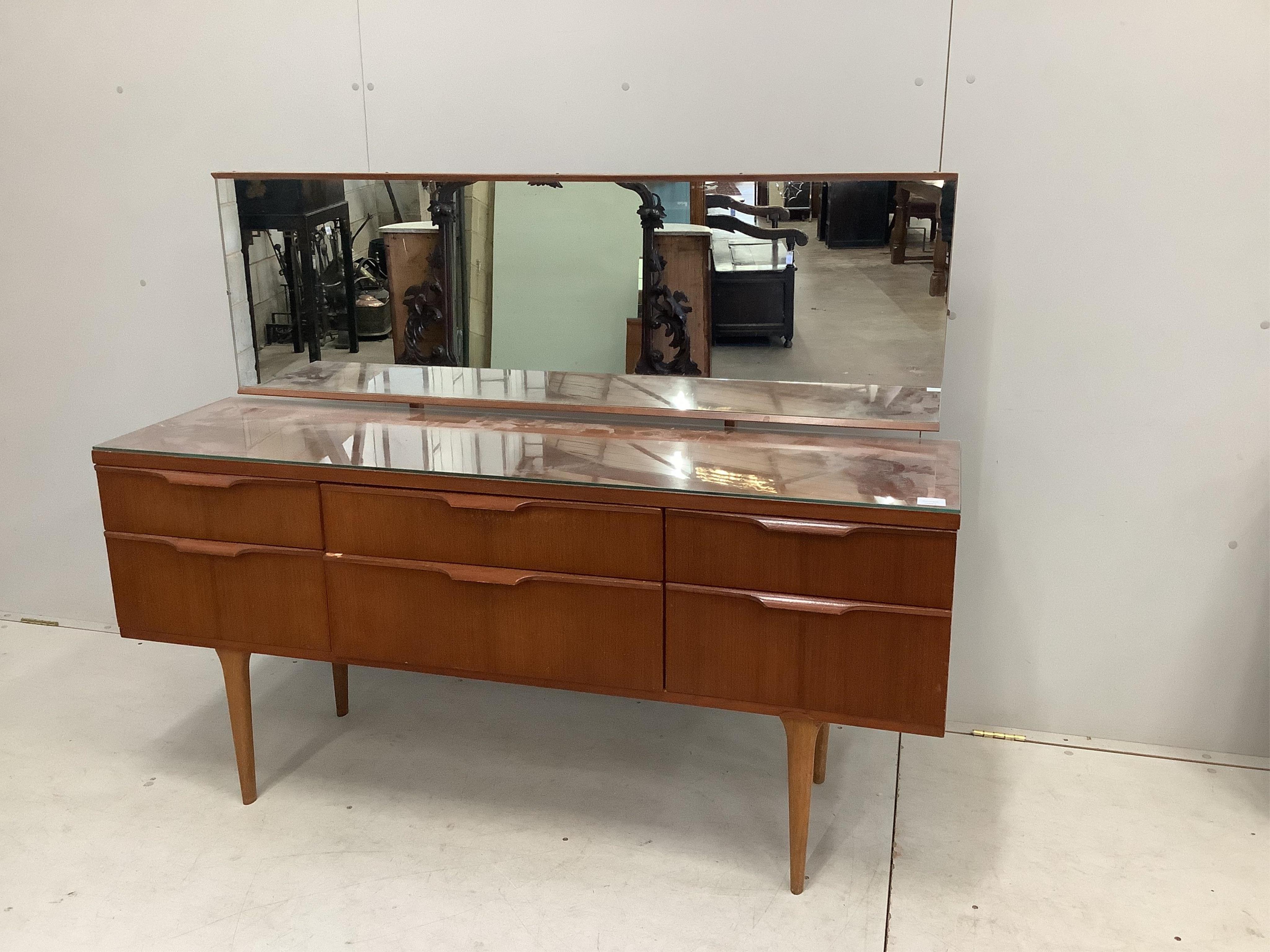 A mid century G plan six drawer dressing table, width 151cm, depth 42cm, height 117cm. Condition - fair to good